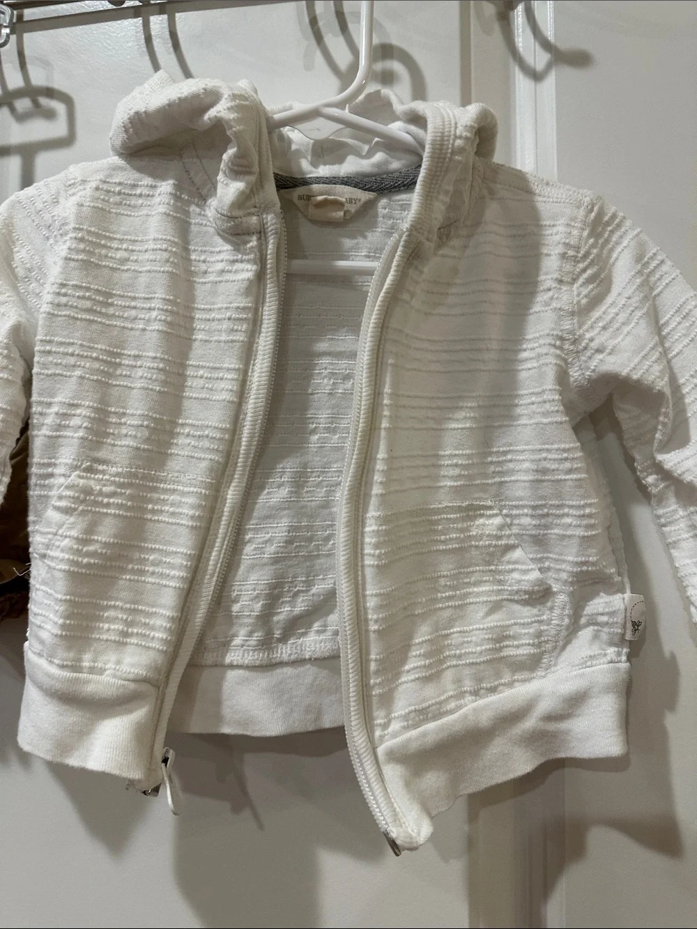 3 Pc Blue & White Striped onsie with Tan Ruffle Shorts and white jacket.